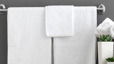 Understanding Bath Towel Sizes hanging on Bar with Succulents