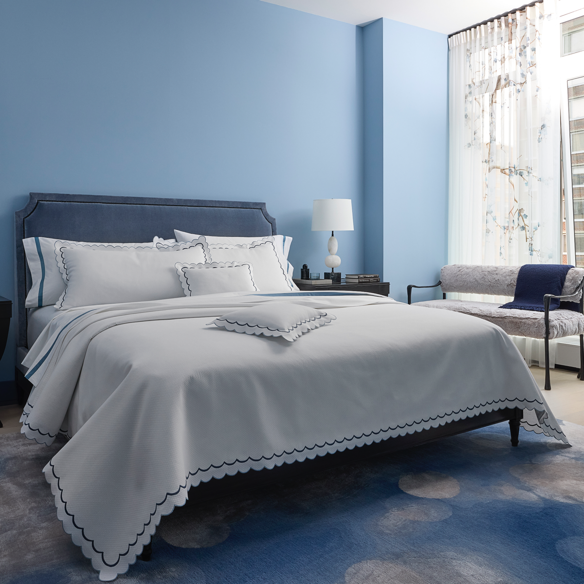 Full Bedding in a Room Dressed in Matouk India Pique Collection in Hazy Blue Color