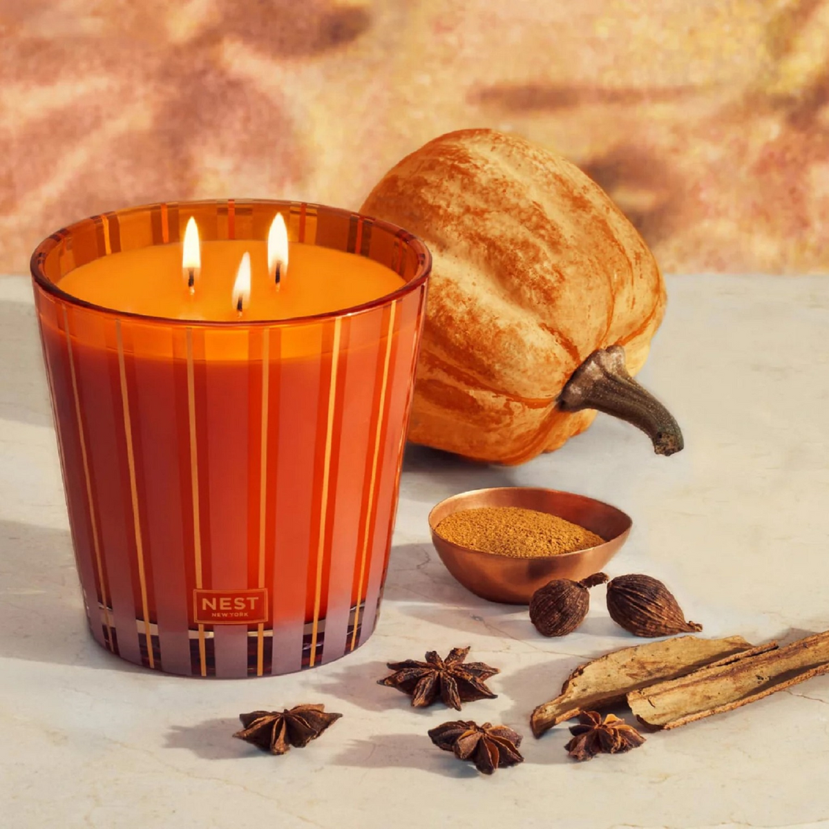 Topview Lifestyle Photo of Nest New York’s Pumpkin Chai 3 Wick Candle
