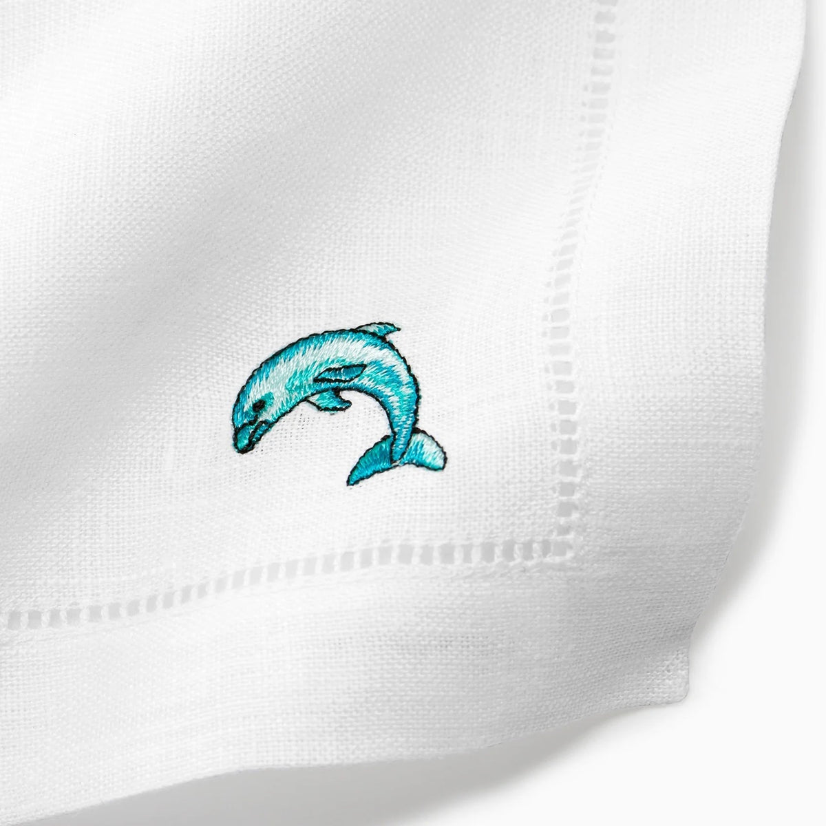 Close Up Shot of Sferra Amalfi Cocktail Napkins with Embroidered Dolphin