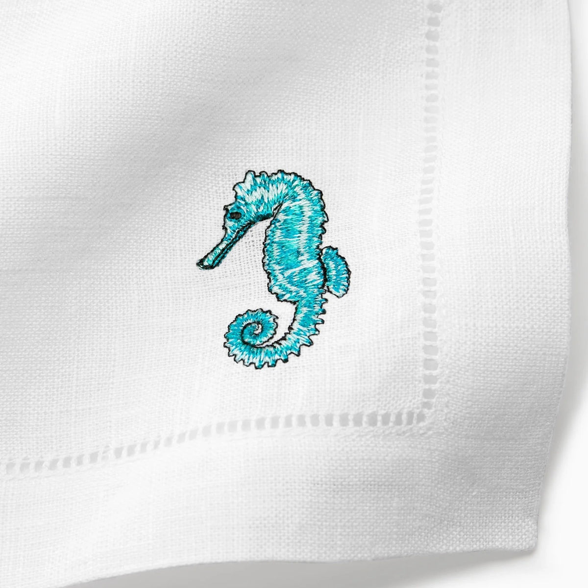 Close Up Shot of Sferra Amalfi Cocktail Napkins with Embroidered Seahorse
