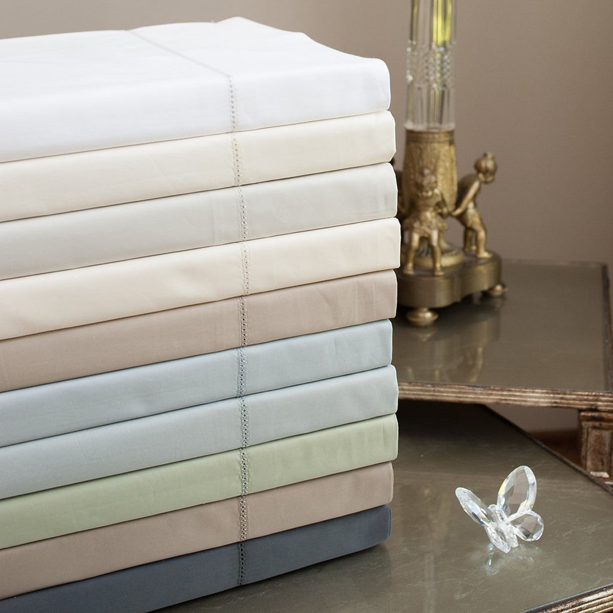 Stack of Home Treasures Perla Percale Bedding in Different Colors