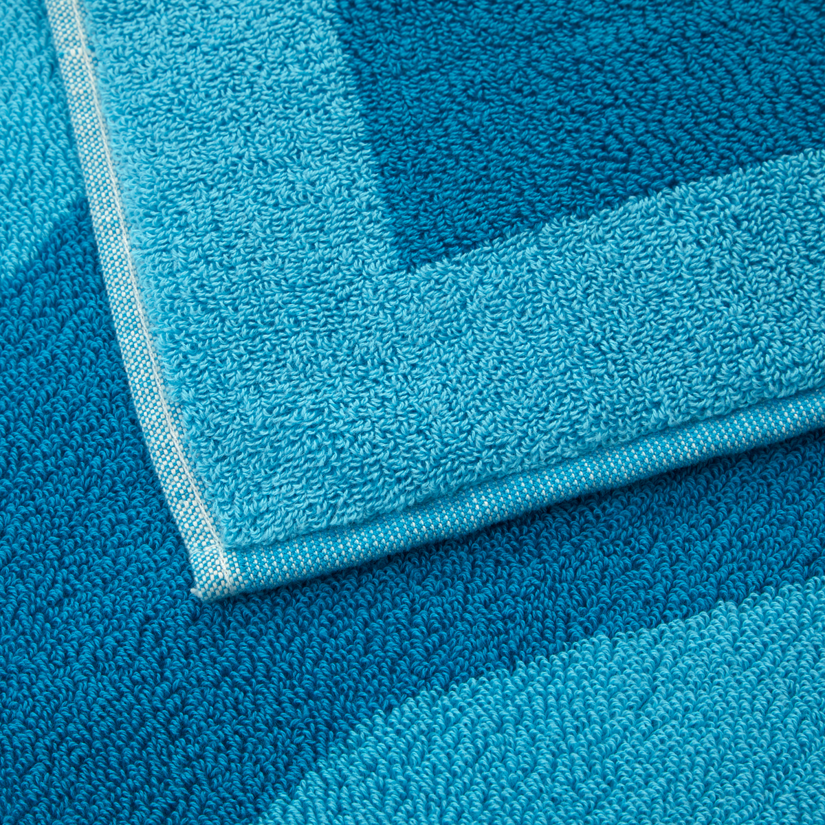 Close Up Image of Yves Delorme Griffe Beach Towel in Jacuzzi Color