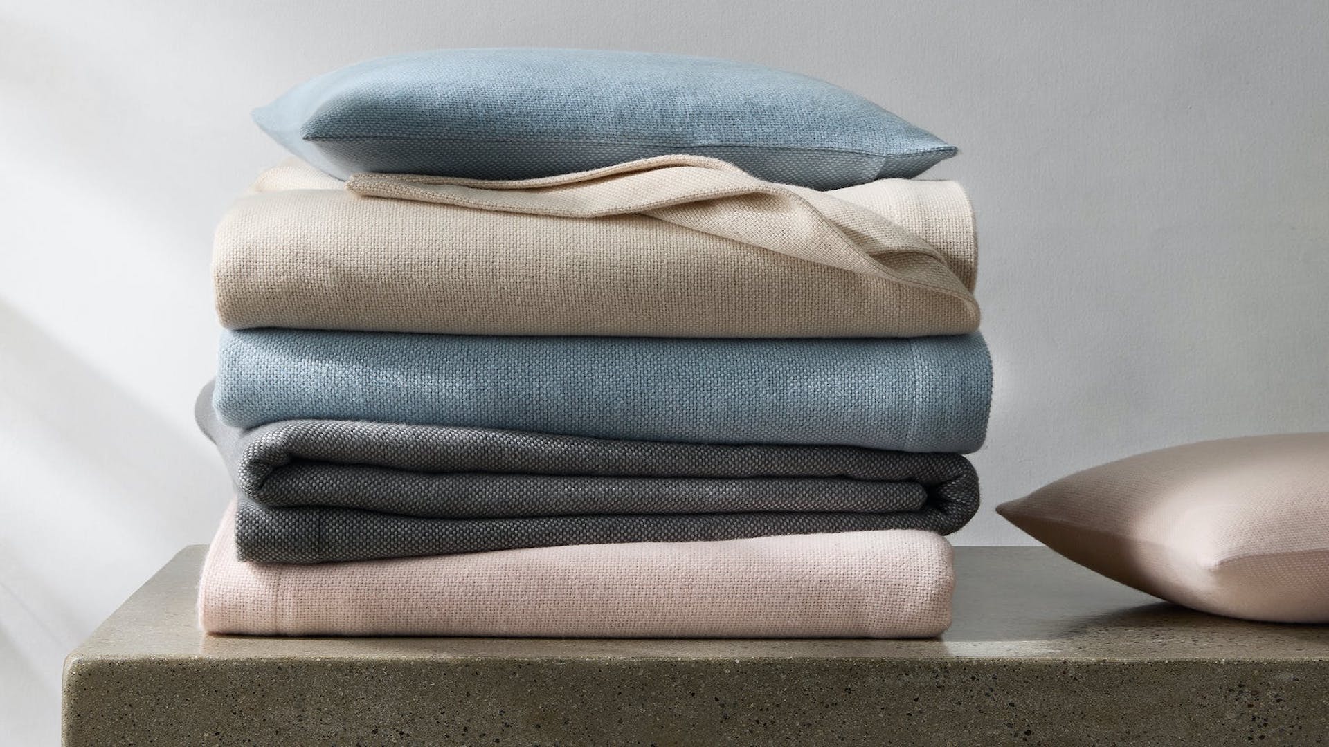 Matouk Webster Blanket (top to bottom) in Dune, Hazy Blue, Pink and Charcoal