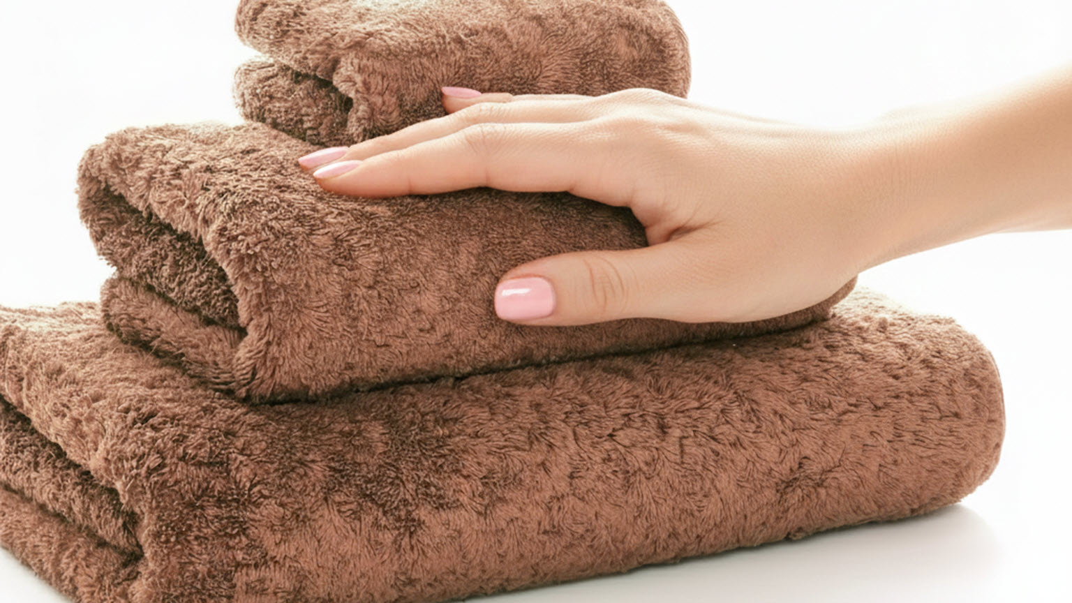 Hand touching a Graccioza Egoist Bath Towel