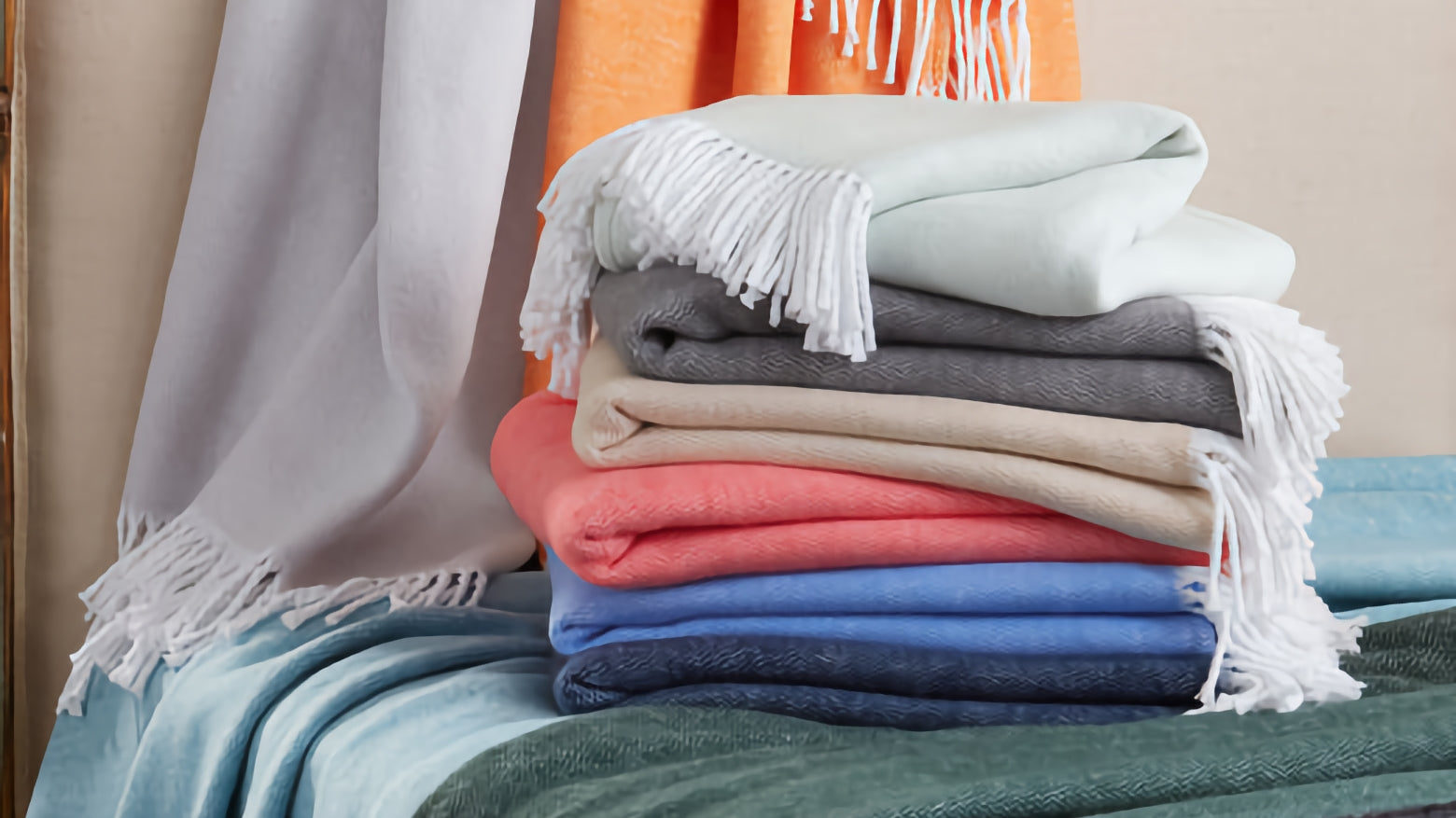 A stack of high end throw blankets