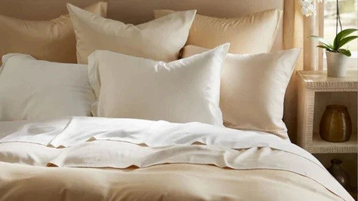 Luxury Sheets for All Seasons (and Climates): A Buyer’s Guide Pillows Fine Linens on Bed in Bedroom