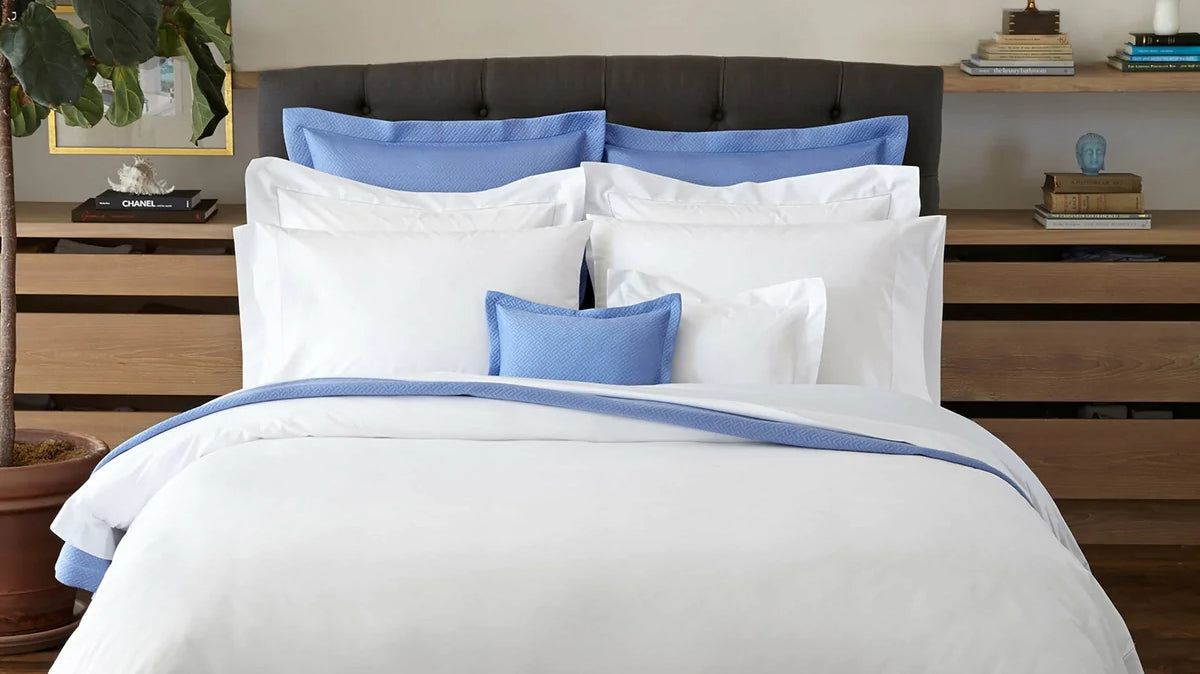 White and blue complete bedding fixed on mattress