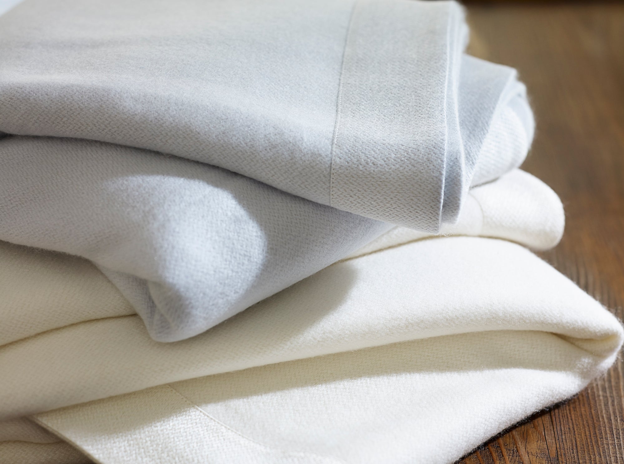 Style and Warmth for Your Bed: A Buyer’s Guide To Luxury Blankets Folded Piled Fine Linens