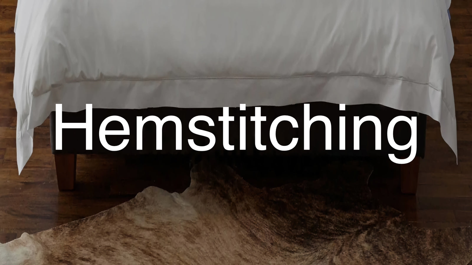 Bottom edge of bed showing hemstitching of cover