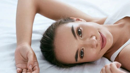 What Are The Best Sheets for Sensitive Skin? Cotton and Silk Beautiful Woman in White on Bed