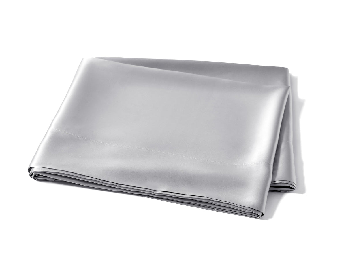 Folded silver silk flat sheet showcasing its smooth texture and high-quality fabric