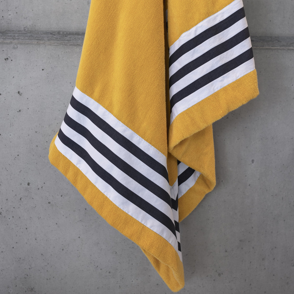 Detailed Shot of Abyss Cannes Beach Towels in Color Curcuma (870)