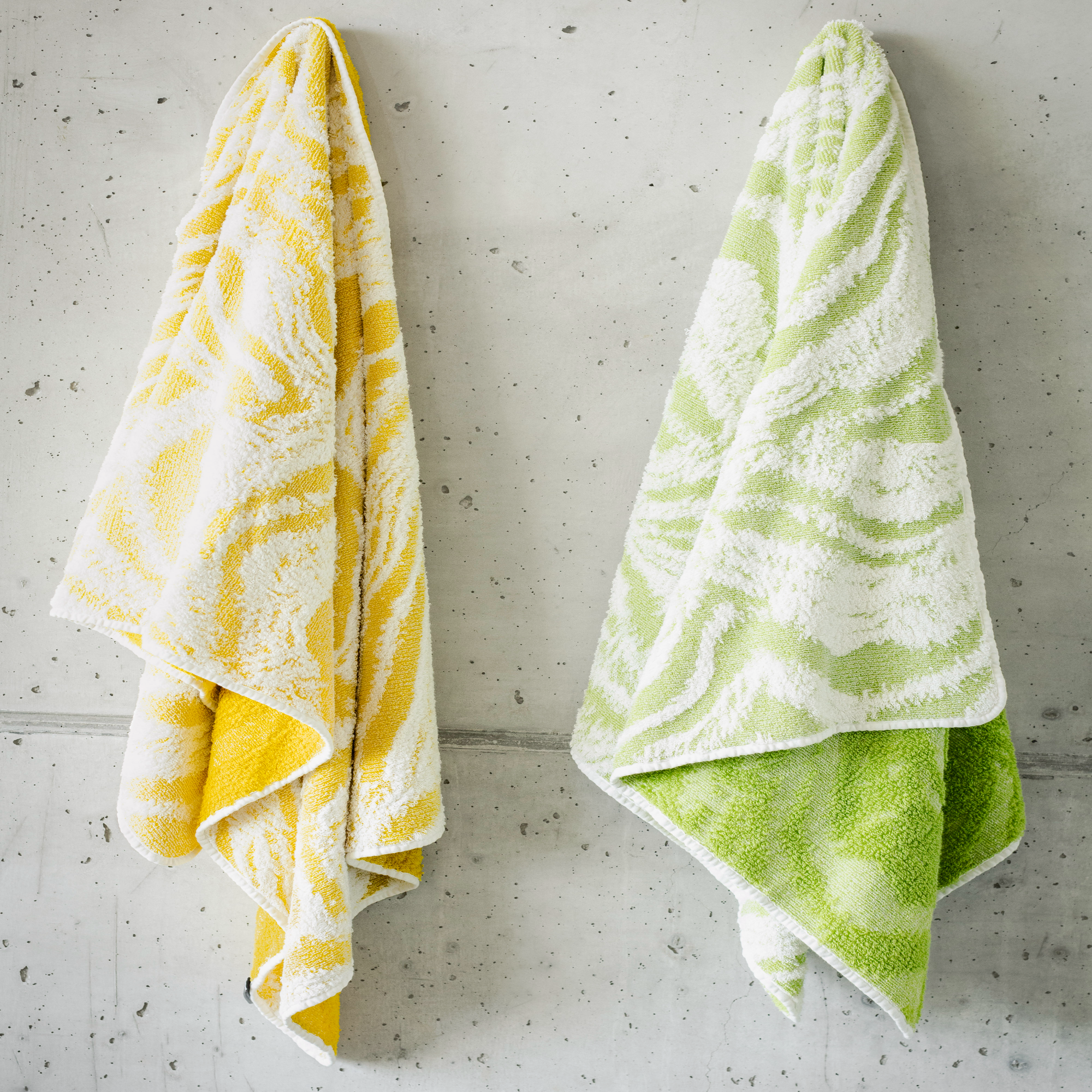 Both Colors of Abyss Fogo Bath Towels Hanging