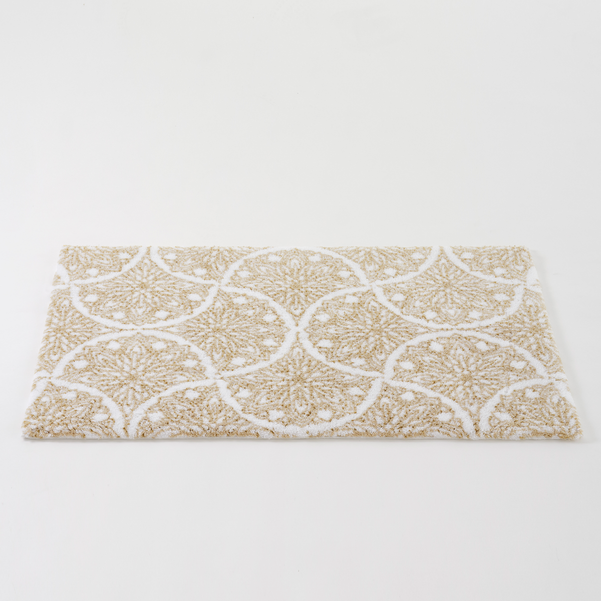 Angled view of Sand color Abyss Habidecor Alambra Bath Rug