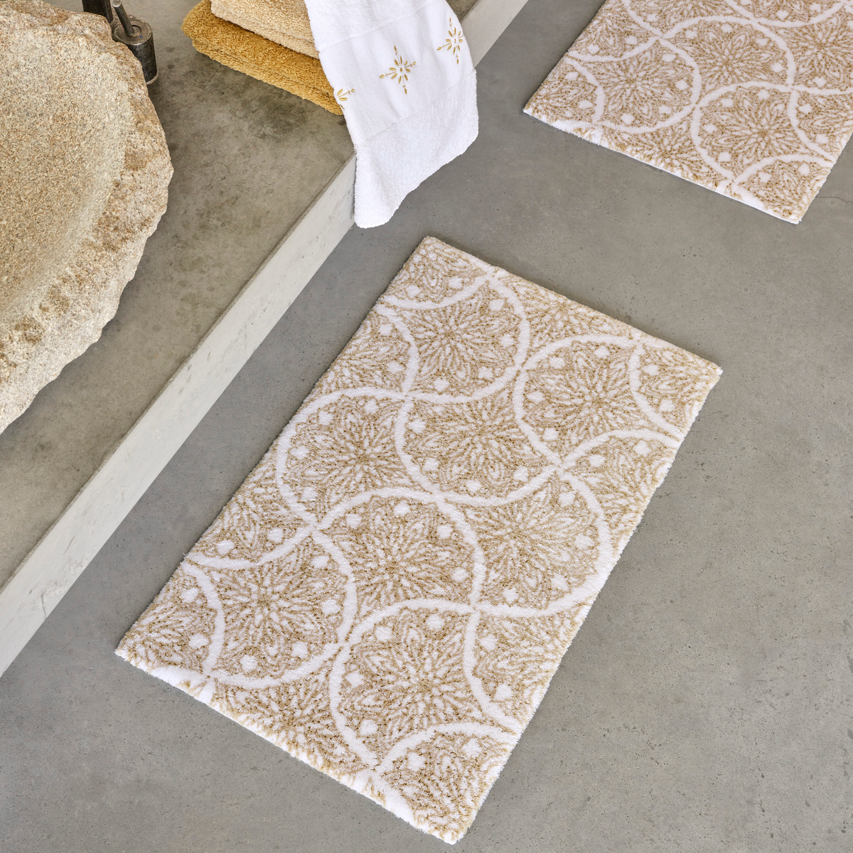 Abyss Habidecor Alambra Bath Rugs on concrete bathroom floor