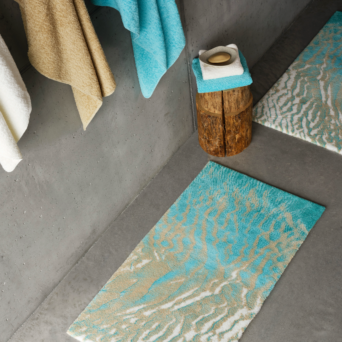 Turquoise colored Abyss Habidecor Beach Bath Rugs with matching towels