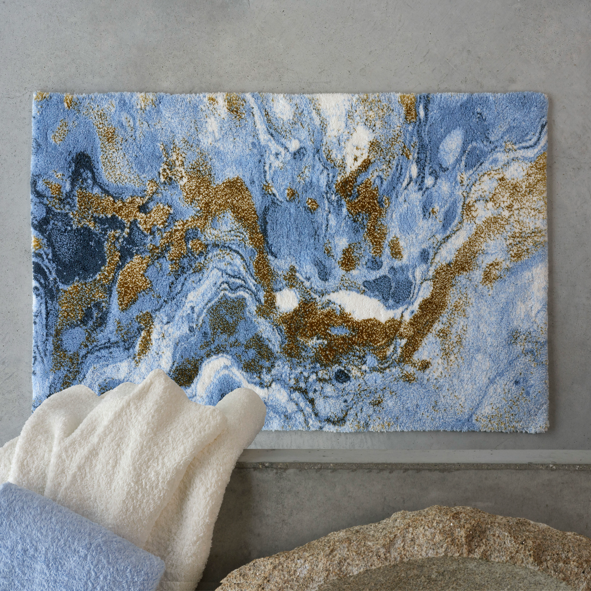 Top view of Powder Blue colored Abyss Habidecor Dandy Bath Rug with matching towels