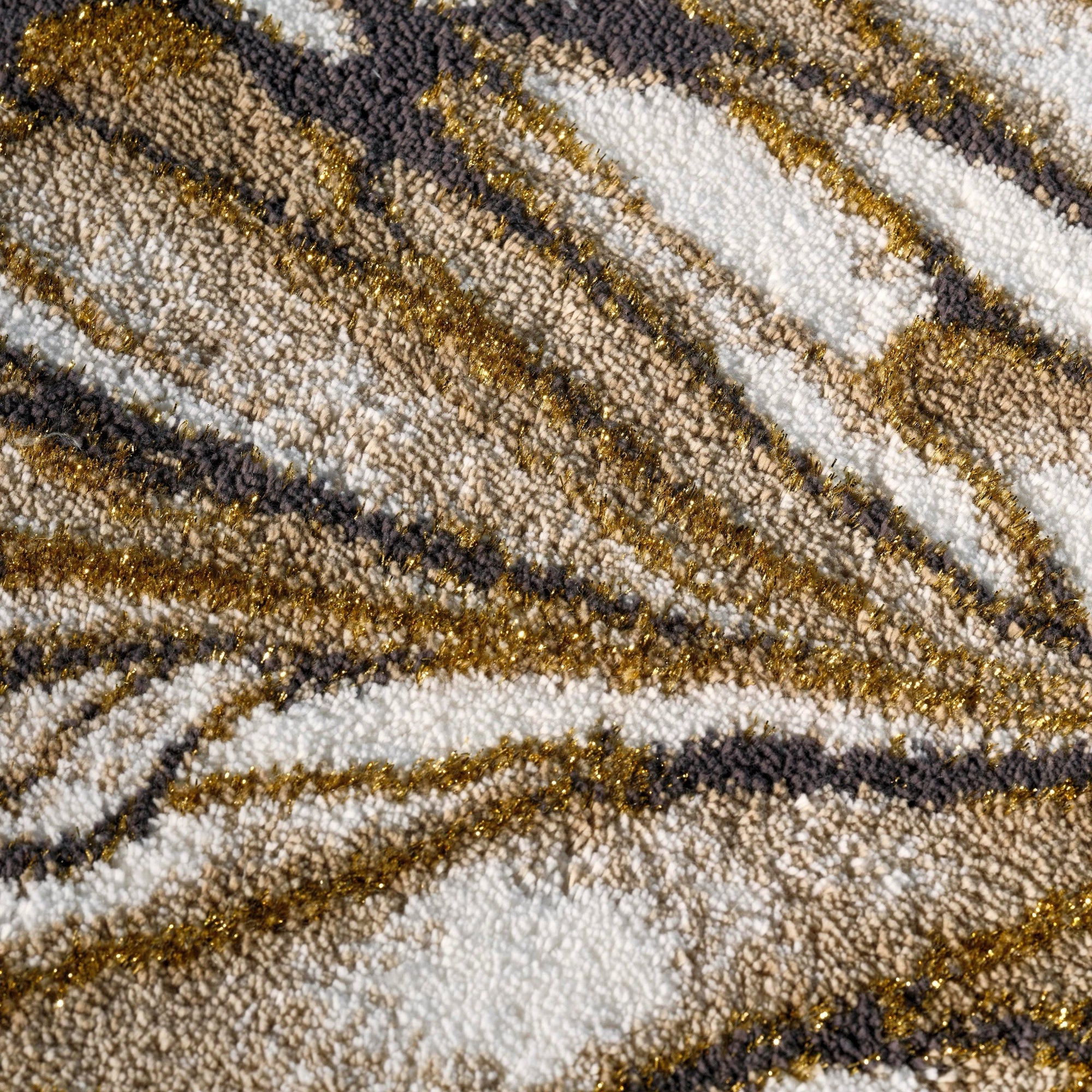 Gold Abyss Habidecor Diane Bath Rug beside stone bath tub