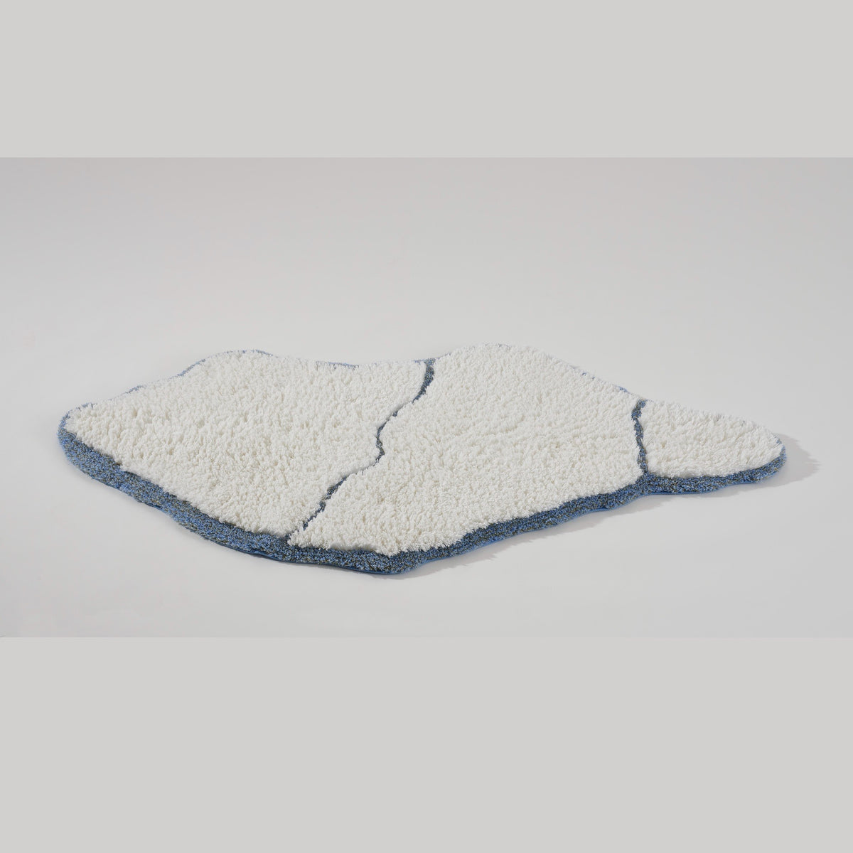 Tilted View of Abyss Habidecor Jess Bath Rug in Powder Blue (330)