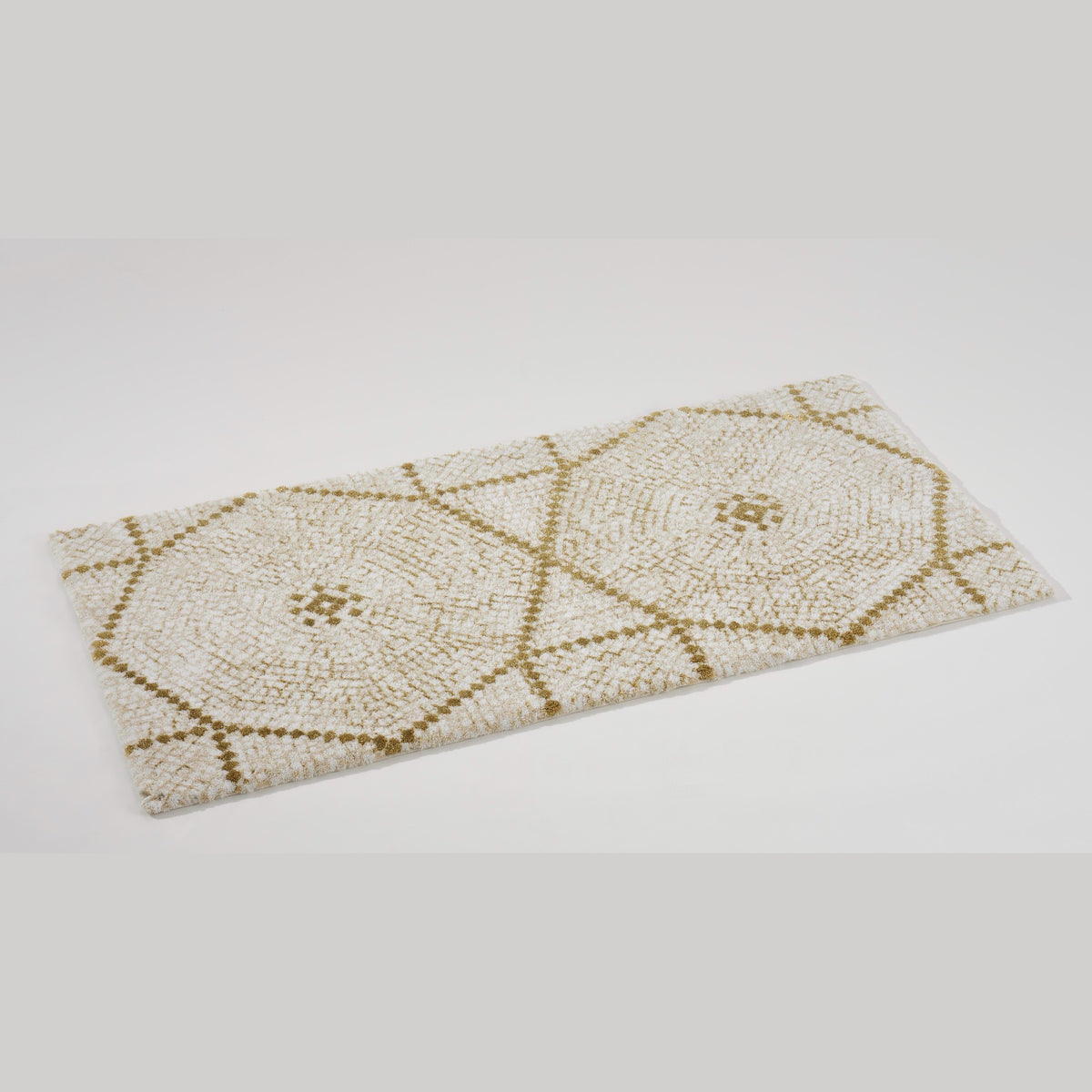 Angled View of Abyss Habidecor Kery Bath Rug in Gold (800)