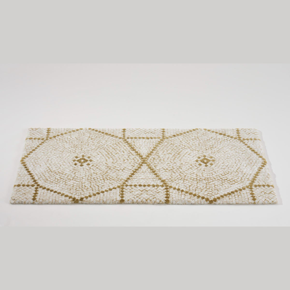 Tilted View of Abyss Habidecor Kery Bath Rug in Gold (800)