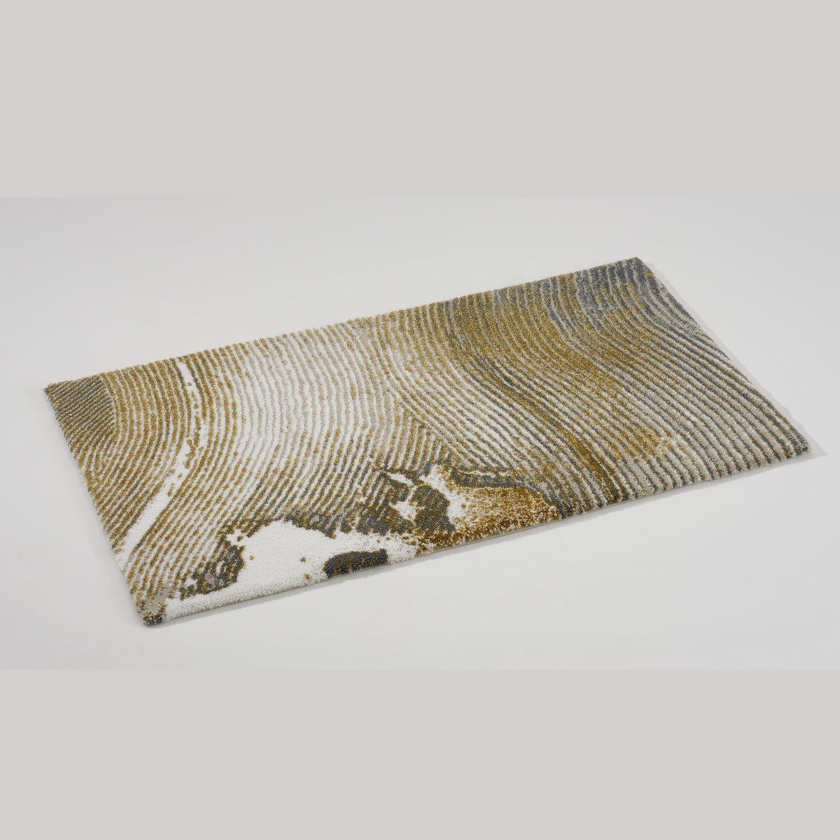 Angled View of Abyss Habidecor Lana Bath Rug in Gold (800)