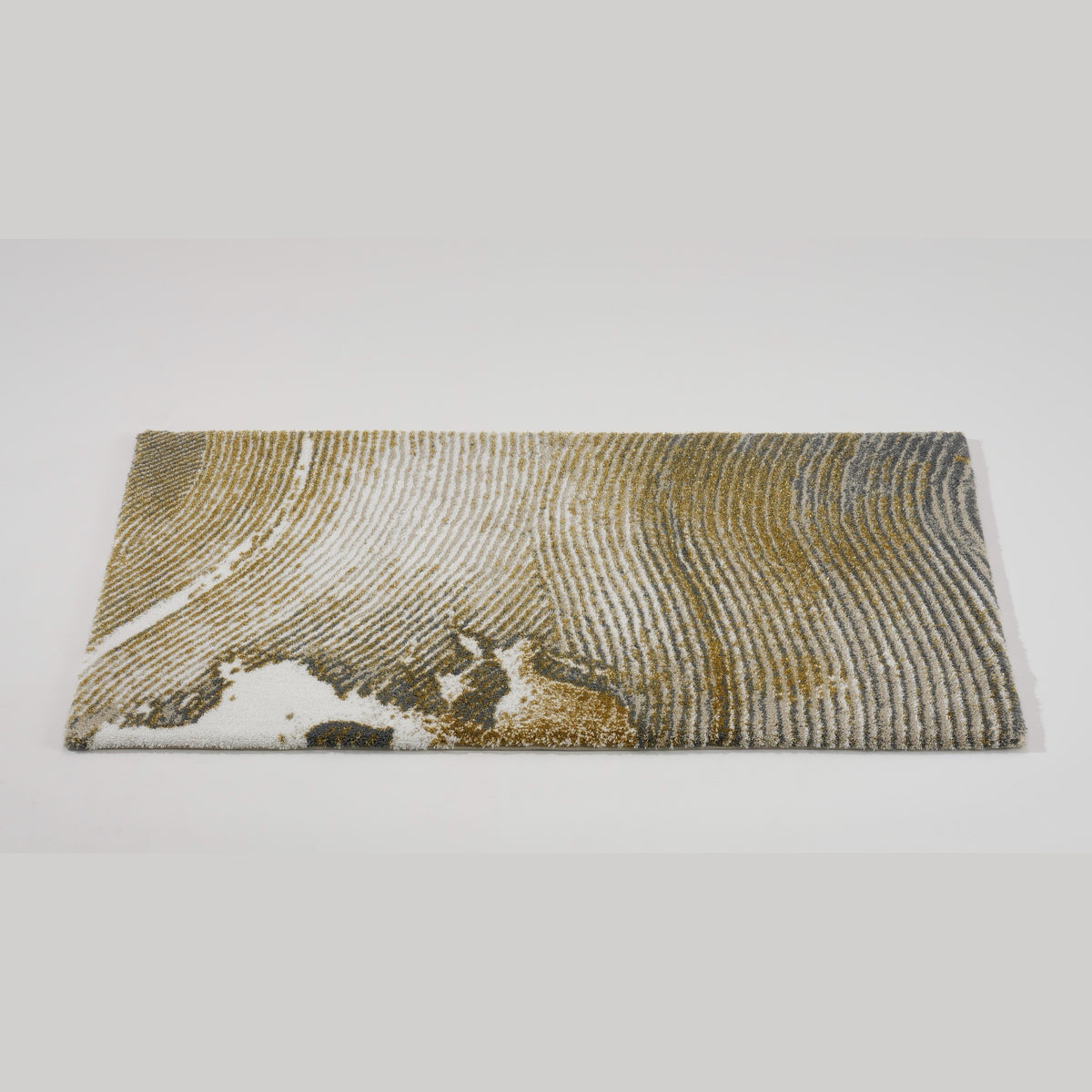 Tilted View of Abyss Habidecor Lana Bath Rug in Gold (800)