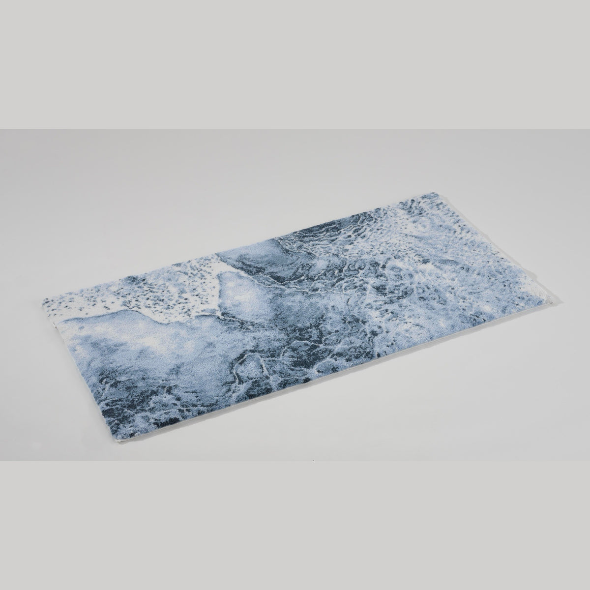 Angled view of Denim (307) Abyss Habidecor Nazare Bath Rug