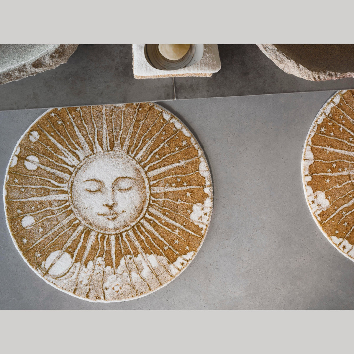 Gold (800) Abyss Habidecor Roi Soleil Bath Rug on cement floor