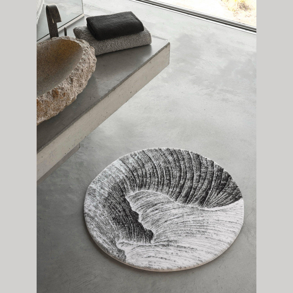 Silver (900) Abyss Habidecor Yoji Bath Rug on cement floor