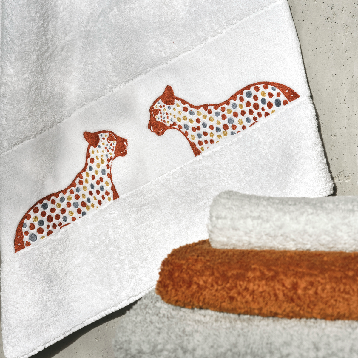 White towel with two embroidered cheetahs, Abyss Leopardo Embroidered Bath Towels in Caramel with matching towels