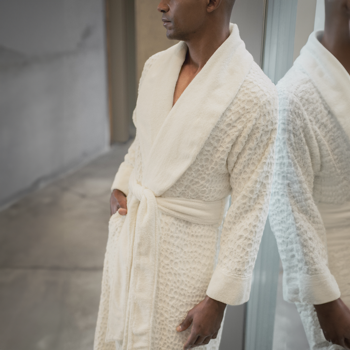 Side view of Model Wearing Abyss Lodge Bath Robe in Ivory Color