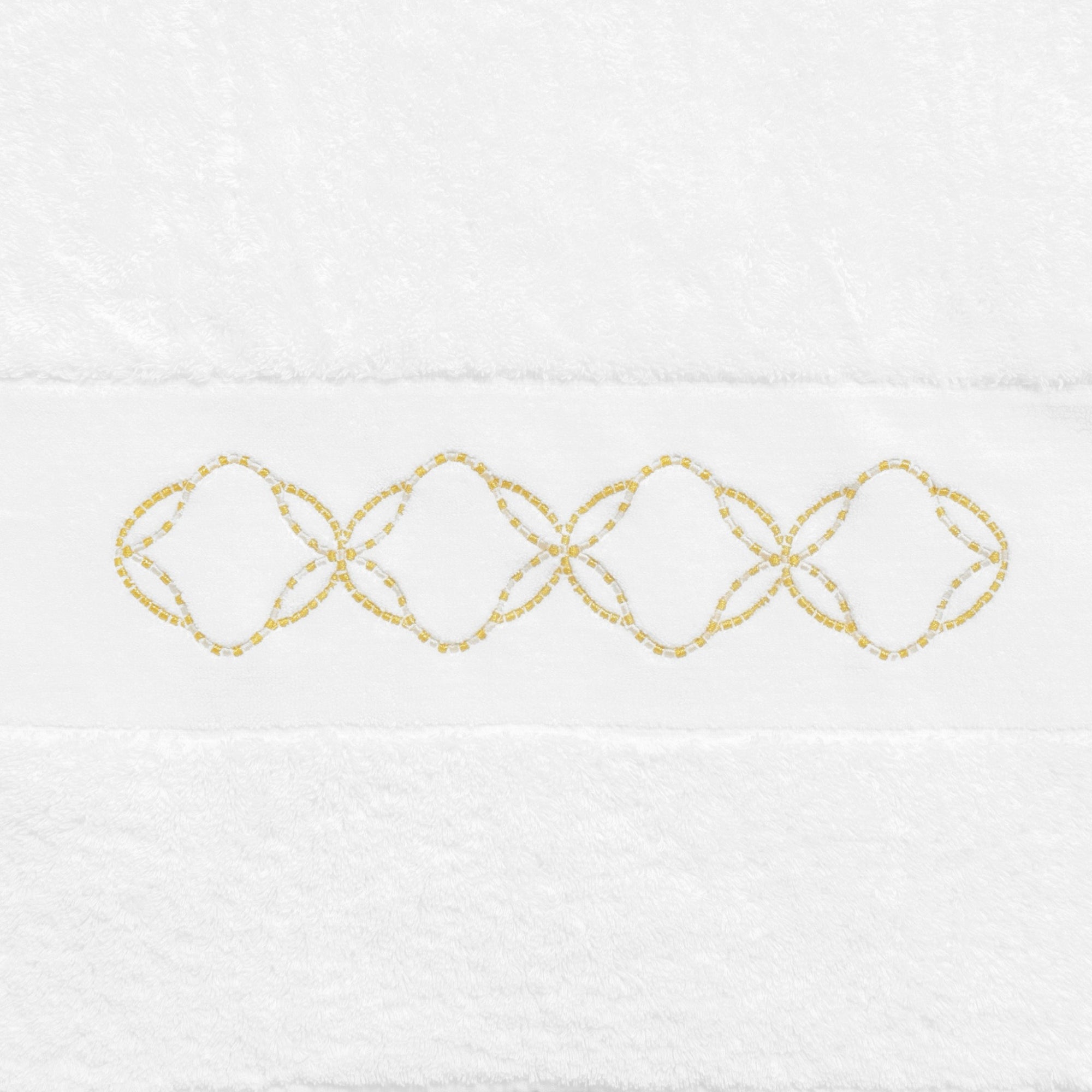 Abyss Misia Embroidered Bath Towels in a bathroom setting hanging on a rod