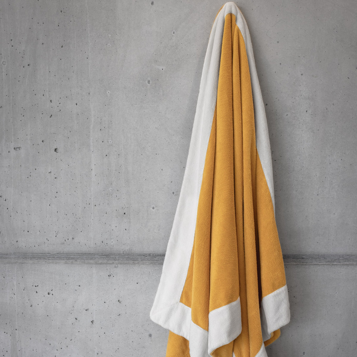 Curcuma Abyss Portofino Beach Towels and Pillows Hung on the Wall