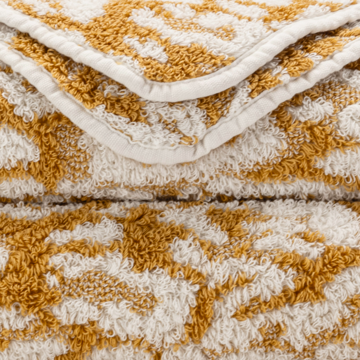 Closeup of Abyss Sauvage Bath Towels in Gold Color