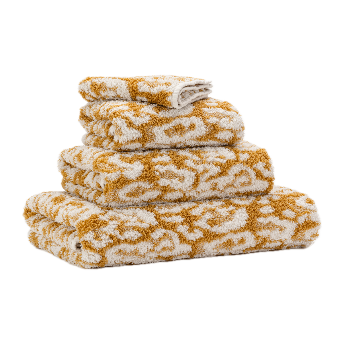 Tilted Stack of Abyss Sauvage Bath Towels in Gold Color