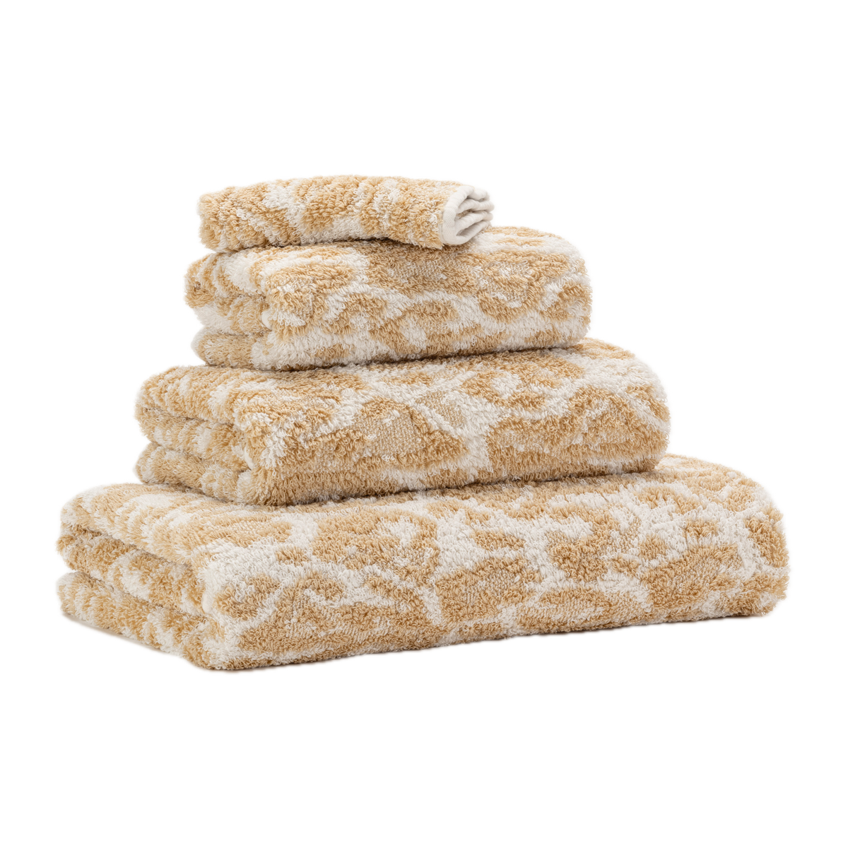 Tilted Stack of Abyss Sauvage Bath Towels in Sand Color