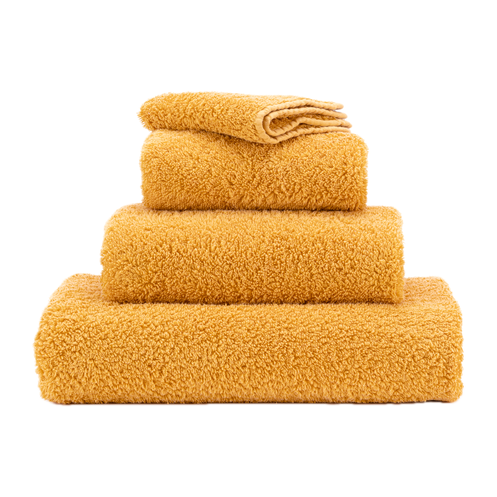 Stack of Abyss Super Pile Bath Towels in Curcuma Color