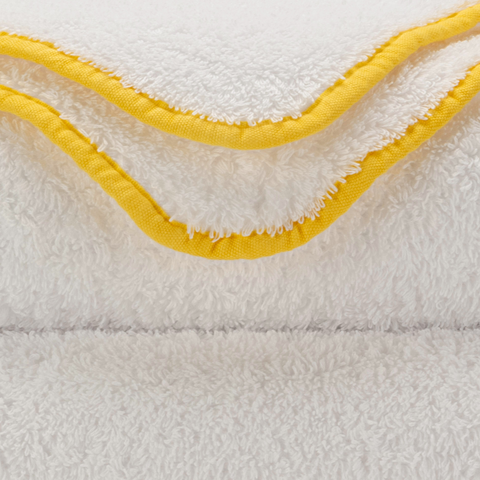 Tilted Stack of Abyss Surf Bath Towels in Banana Color