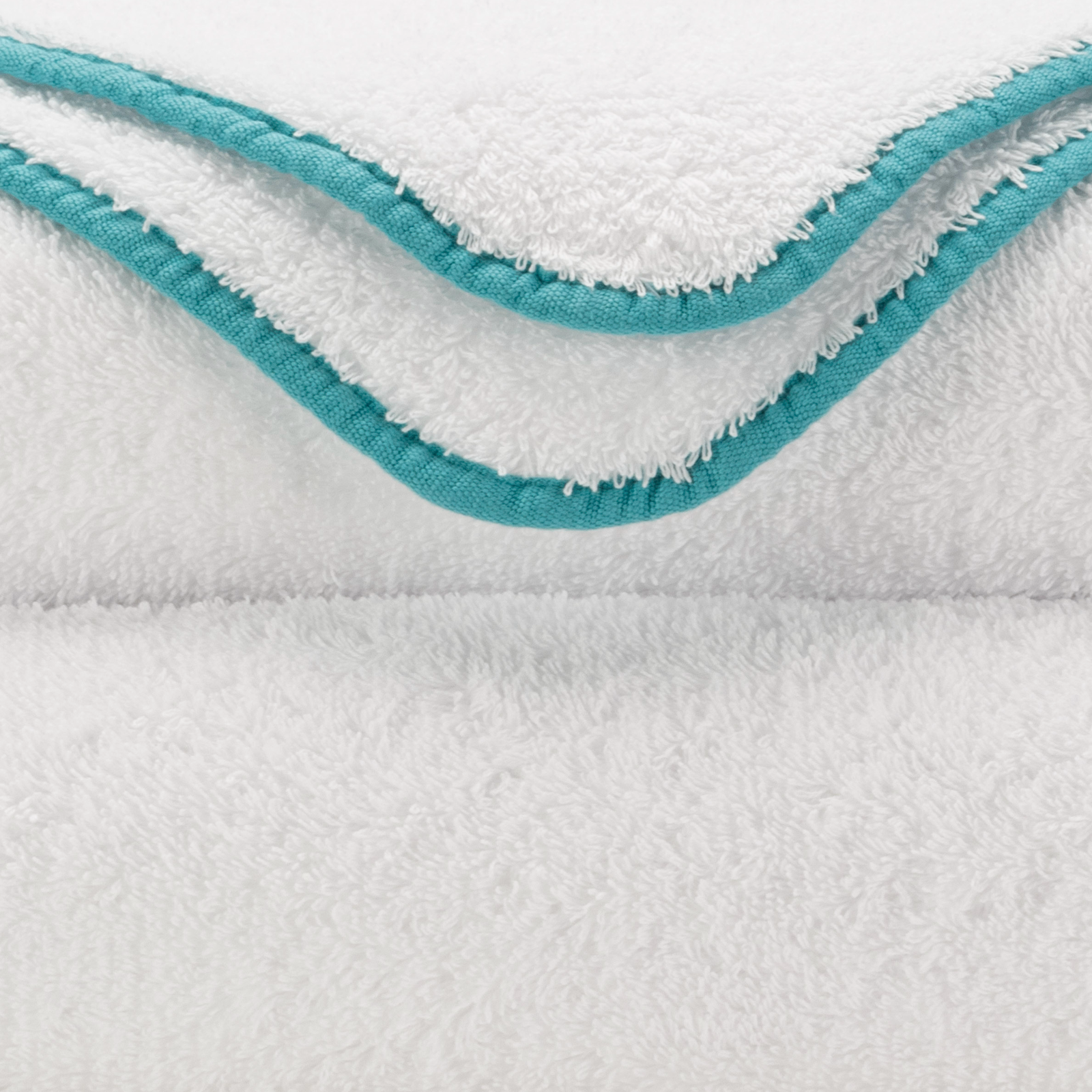 Tilted Stack of Abyss Surf Bath Towels in Lagoon Color