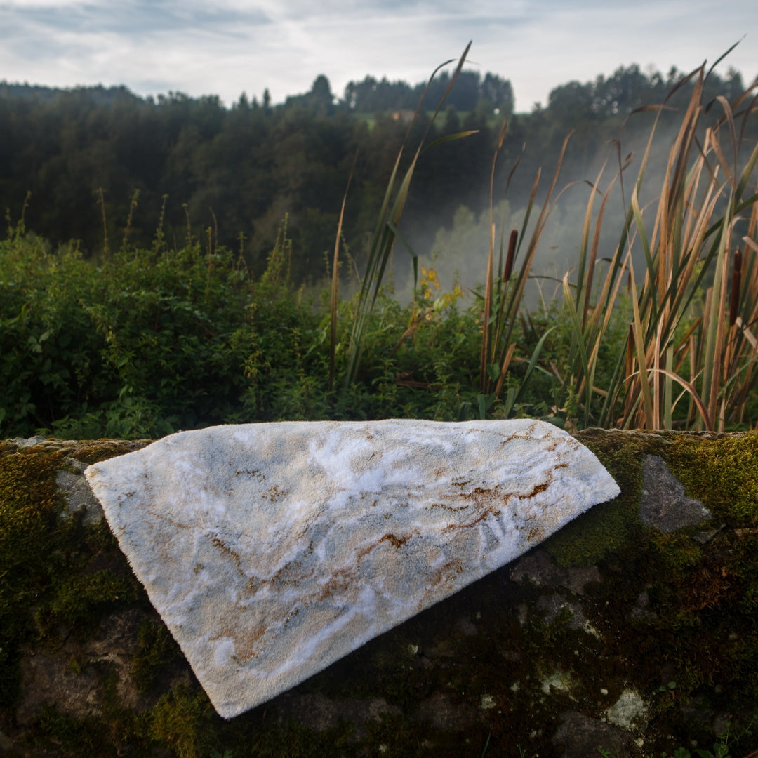 Abyss Habidecor Castello Bath Rug draped over a wall