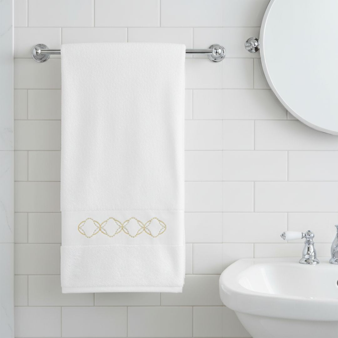 Abyss Misia Embroidered Bath Towels in a bathroom setting hanging on a rod