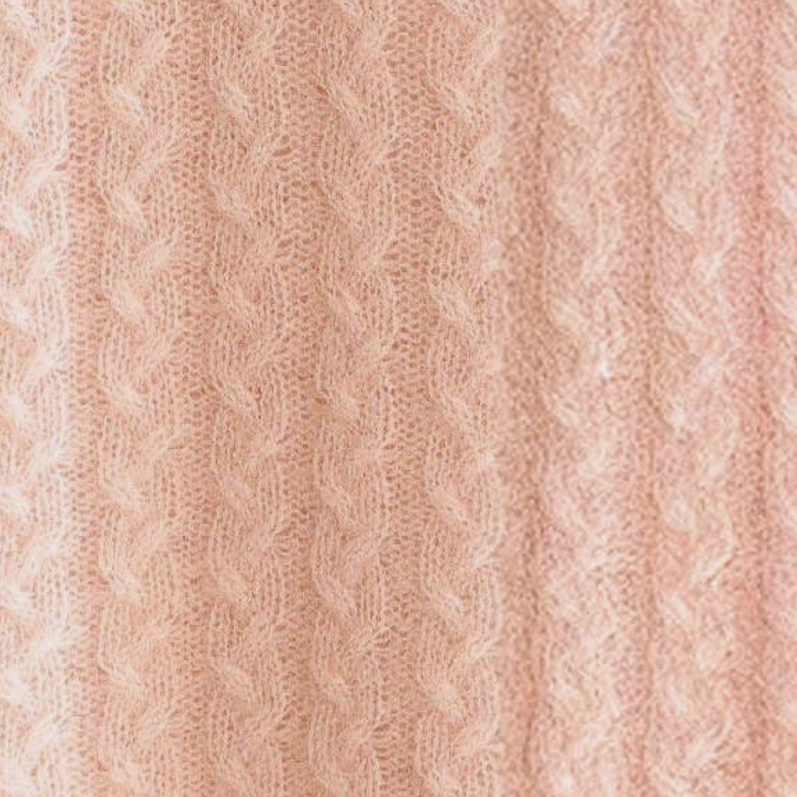 Lip Gloss Alashan Bailey Braided Cable Knit Baby Blanket on a couch