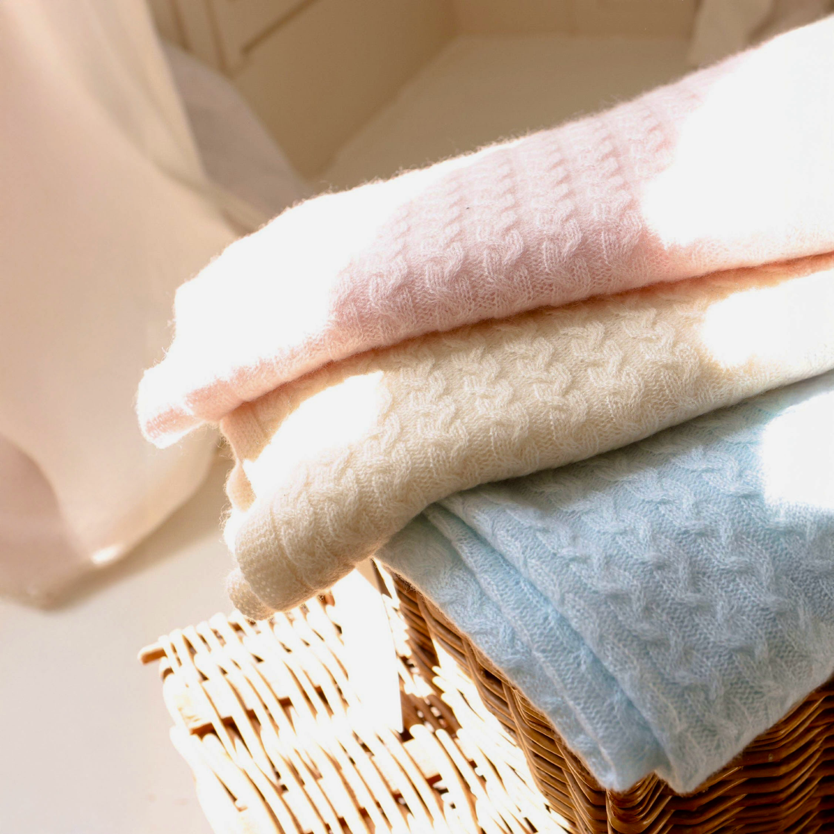 Stack of Alashan Bailey Braided Cable Knit Baby Blankets