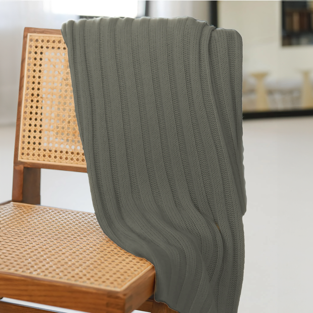 Alashan Chunky Rib Throw in Ash on a chair