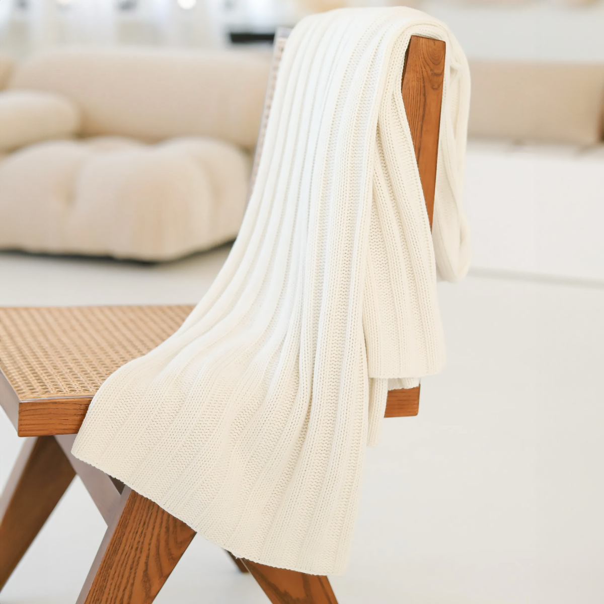 Side view of Alashan Chunky Rib Throw in White on a chair