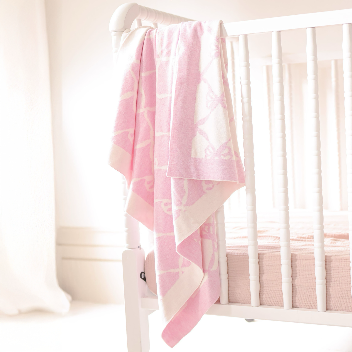 Hanging Alashan Ellis Bow Knit Baby Blanket in Bermuda Pink