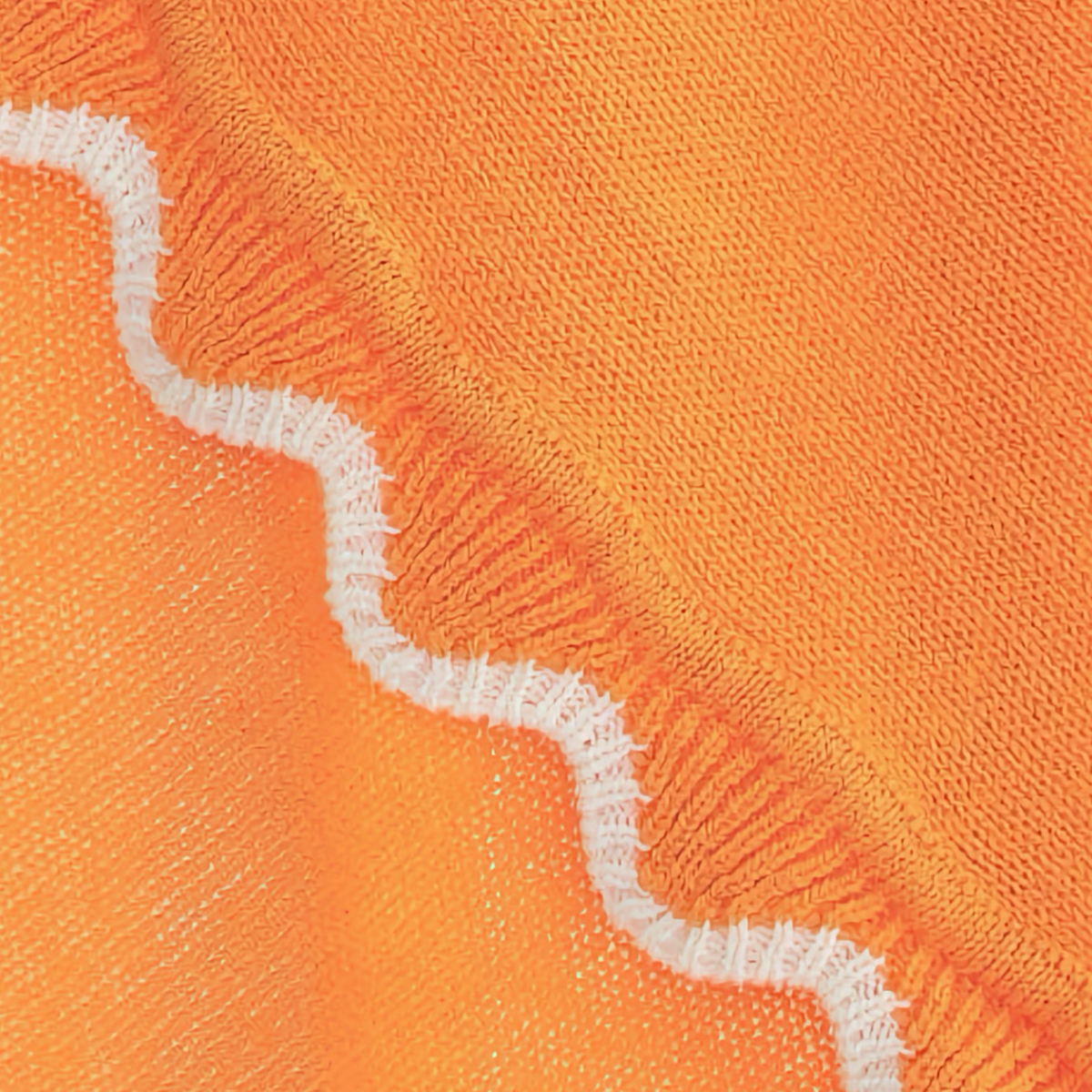 Closeup of Alashan Finley Scallop Knit Baby Blanket in Mango