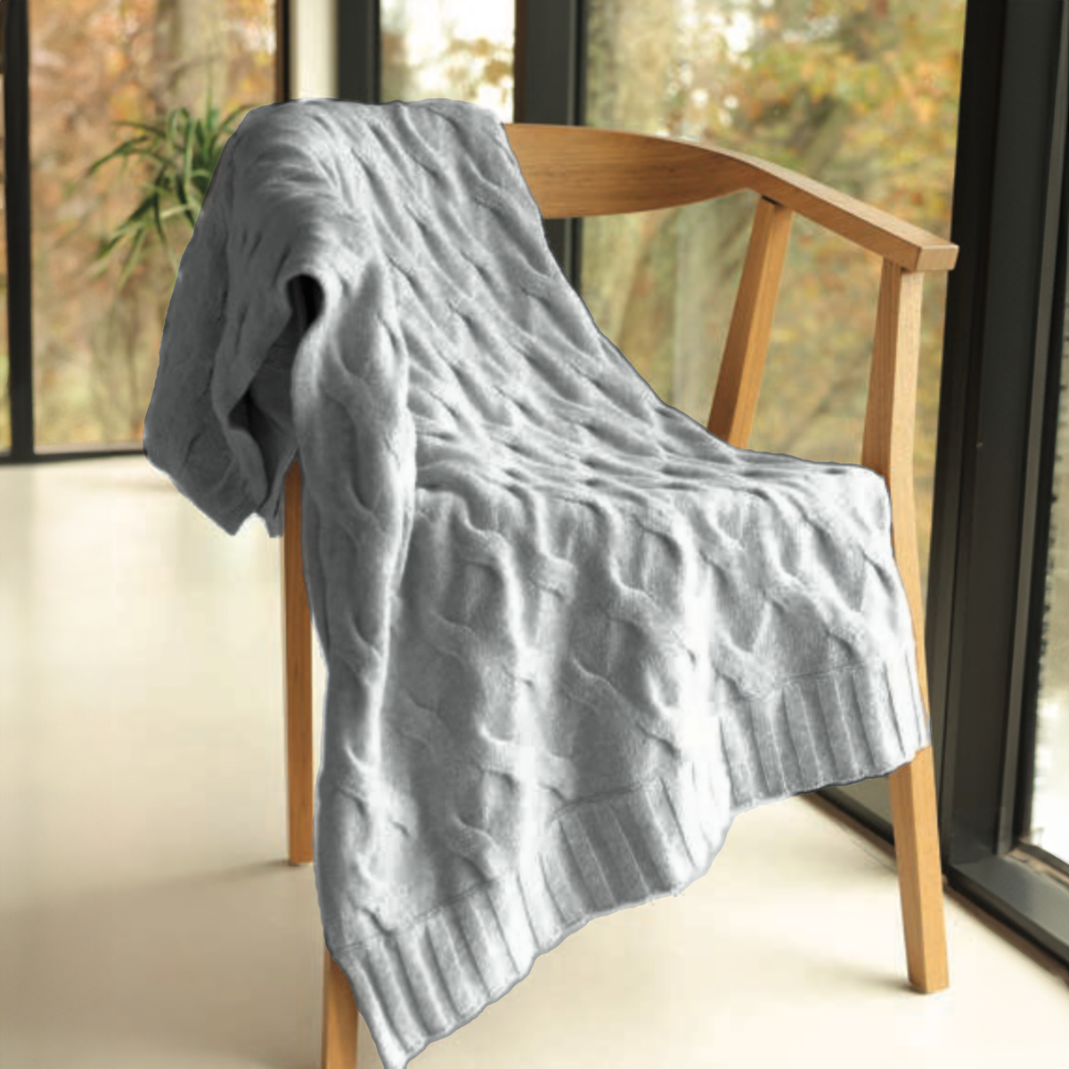 Alashan Galway Throw in Vapor on a chair